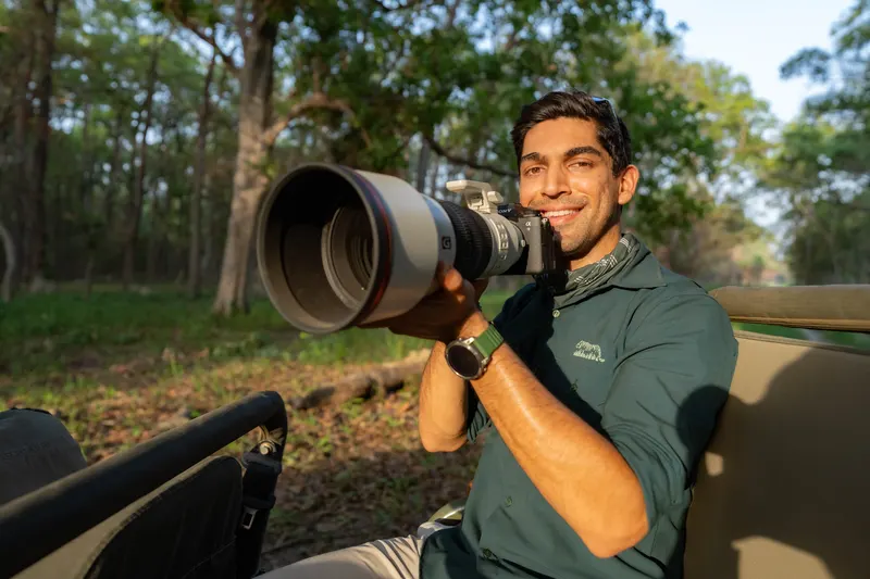 Suyash Keshari with a long-lens camera in a safari vehicle