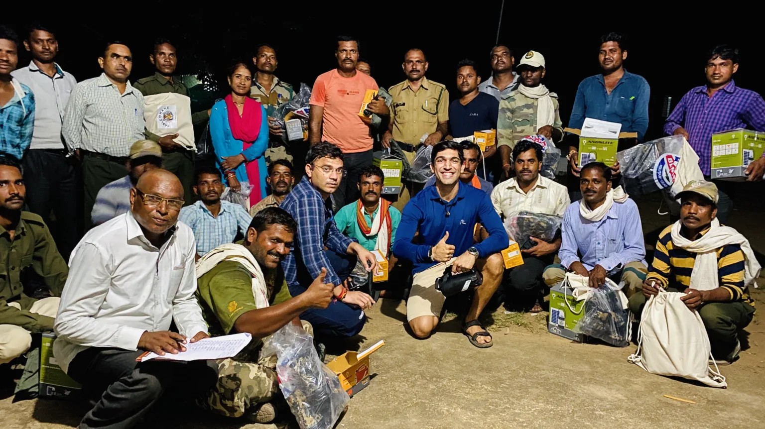 Suyash Keshari with a group of forest staff holding newly issued kit